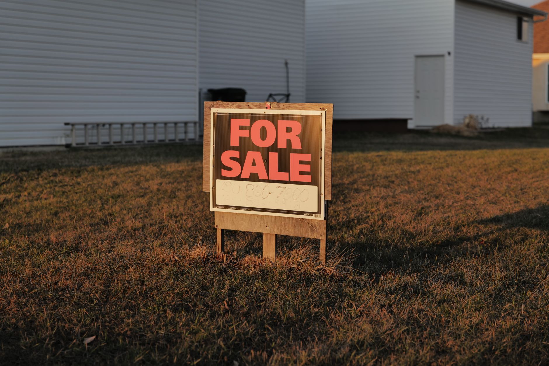 A modern house with a For Sale sign in the front yard, showcasing a real estate listing